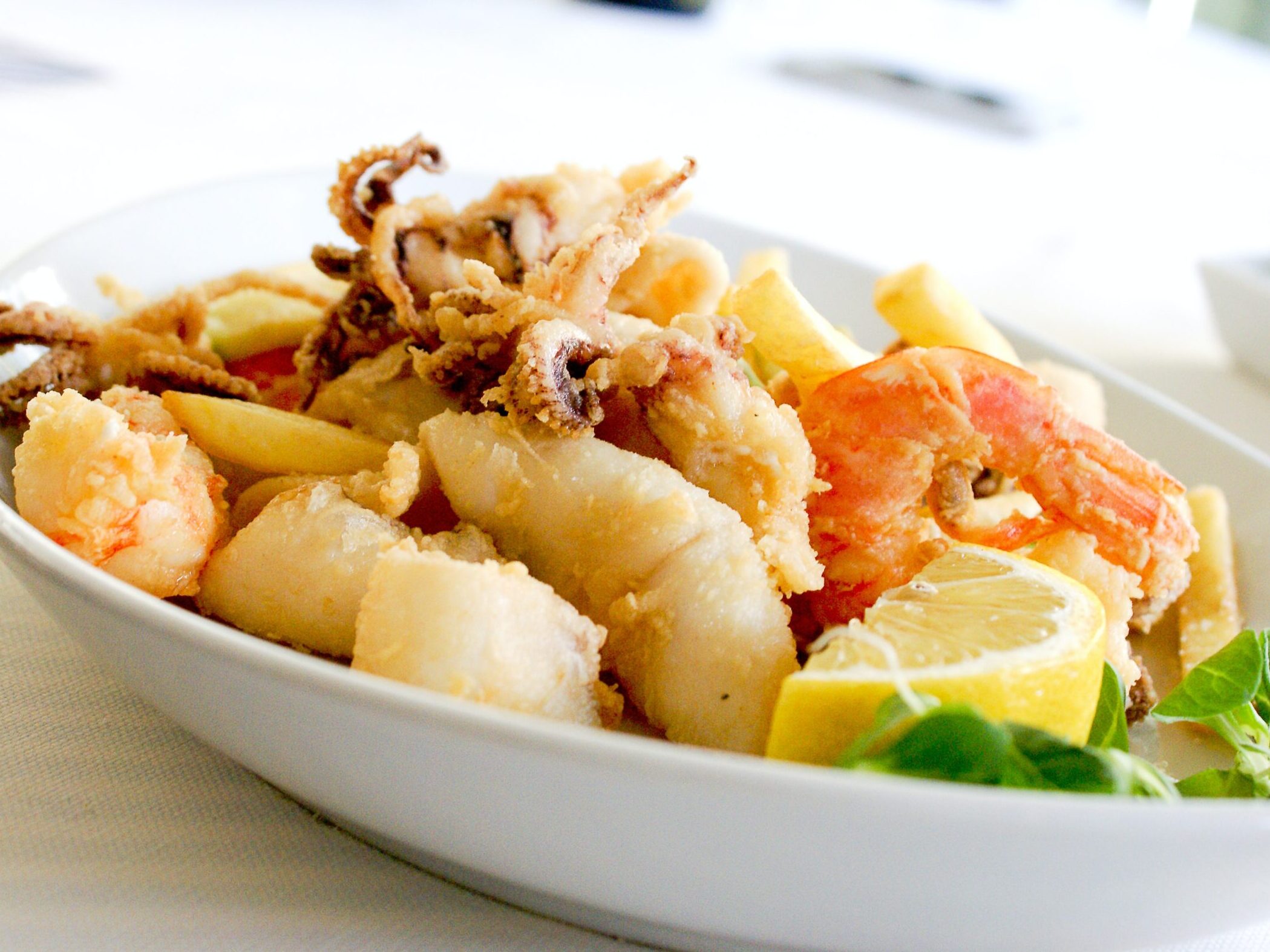 Actual item may vary from image shown Deep Fried Shrimp and Squid With Slice of Lemon on Ceramic Plate