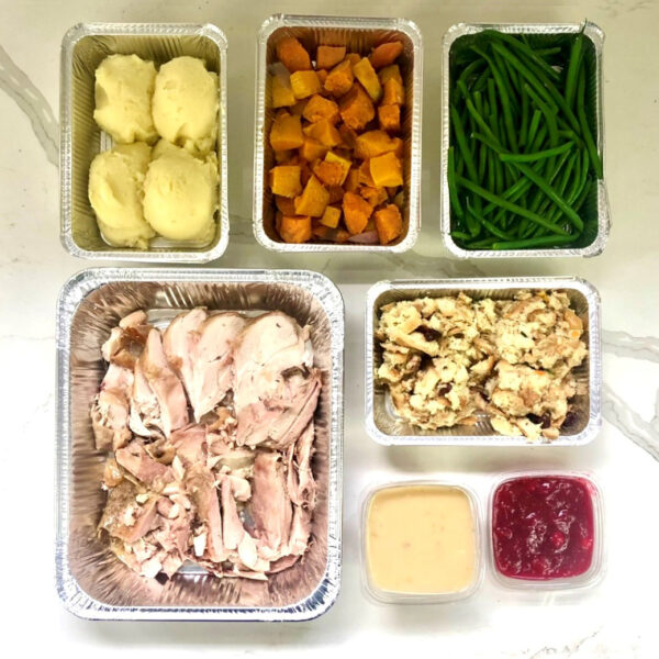 Photo of Cousin's Per Person Turkey Dinner served with side dishes and sauce.