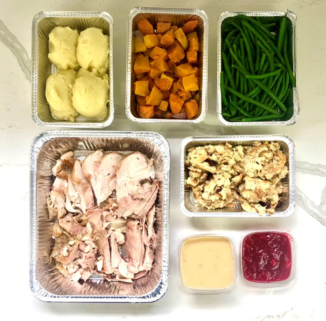 Actual item may vary from image shown Photo of Cousin's Per Person Turkey Dinner served with side dishes and sauce.